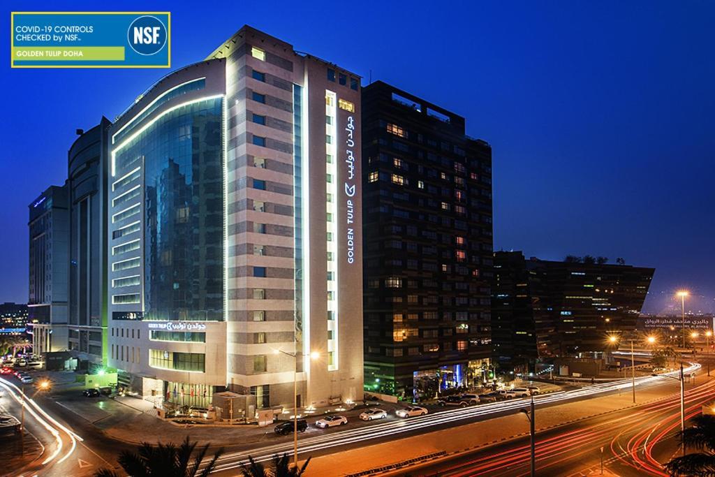 Golden Tulip Doha Hotel Exteriör bild The hotel at night